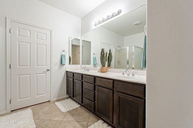 bathroom with walk in shower, tile patterned flooring, and vanity