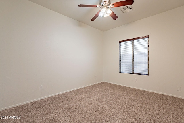 carpeted spare room featuring ceiling fan