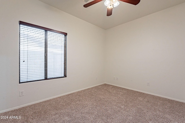 carpeted spare room featuring ceiling fan