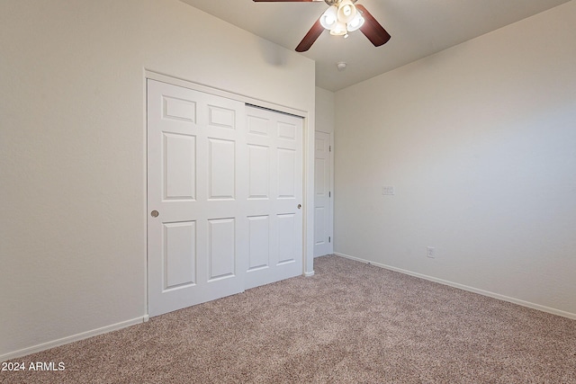 unfurnished bedroom with carpet floors, ceiling fan, and a closet