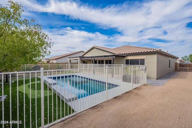 view of pool with a patio and a yard