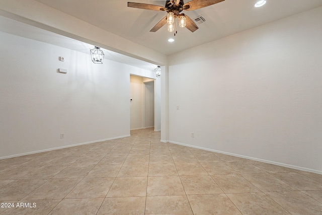 spare room with ceiling fan and light tile patterned flooring