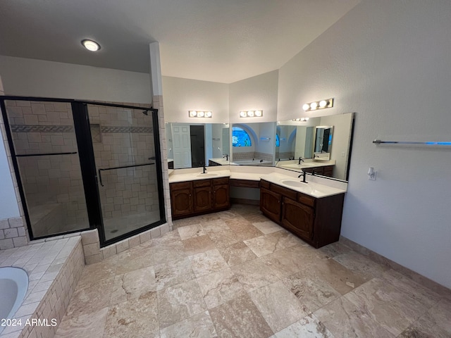 bathroom with dual bowl vanity, shower with separate bathtub, and tile patterned flooring