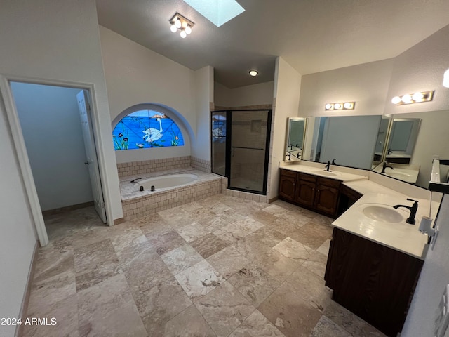 bathroom with dual bowl vanity, plus walk in shower, lofted ceiling with skylight, and tile patterned flooring