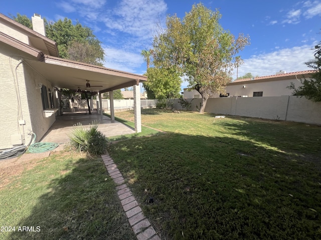 view of yard featuring a patio area, a fenced backyard, and a ceiling fan