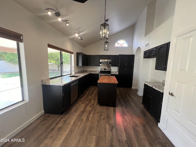 kitchen featuring visible vents, butcher block counters, a kitchen island, stainless steel appliances, and a sink