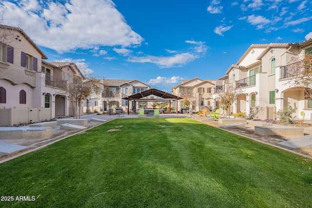 surrounding community with a gazebo and a lawn