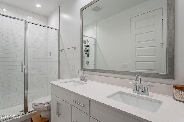 bathroom with toilet, an enclosed shower, and vanity