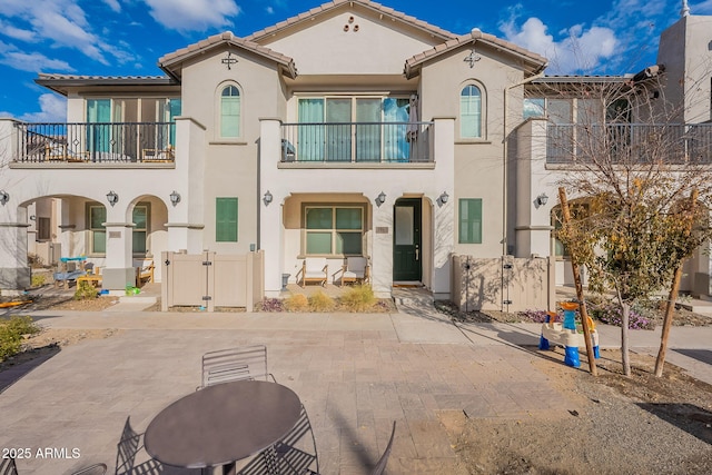 view of front of home featuring a balcony and a patio