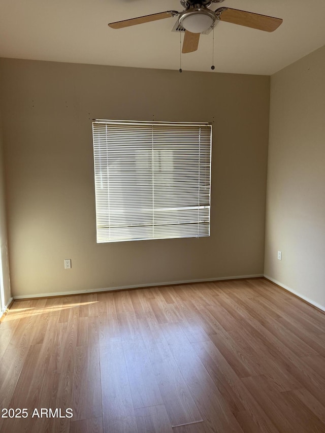 empty room featuring ceiling fan and light hardwood / wood-style floors