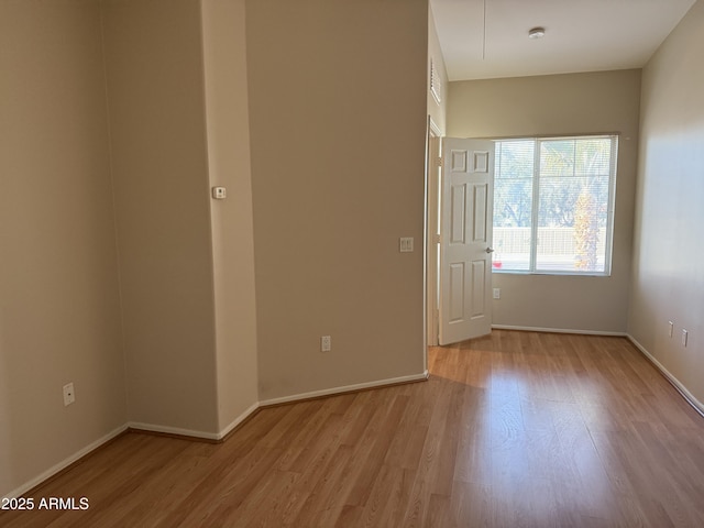 spare room featuring light hardwood / wood-style floors