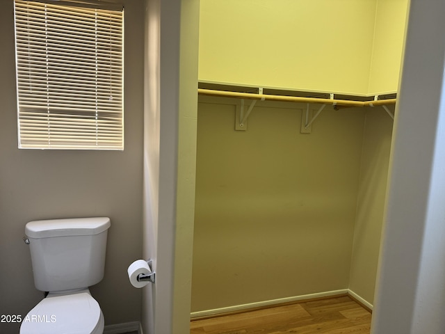 bathroom featuring hardwood / wood-style floors and toilet