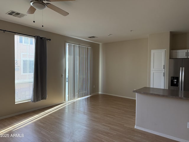 unfurnished living room with ceiling fan and light hardwood / wood-style flooring