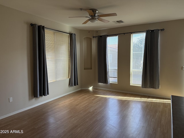 empty room featuring hardwood / wood-style flooring and ceiling fan