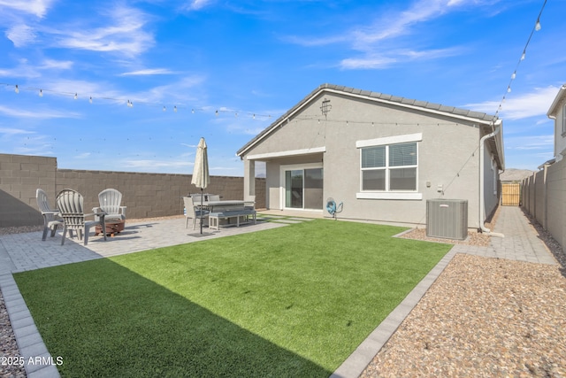 rear view of property featuring a patio, stucco siding, and central AC