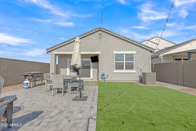 rear view of house featuring a patio area, stucco siding, central AC unit, and outdoor dining area