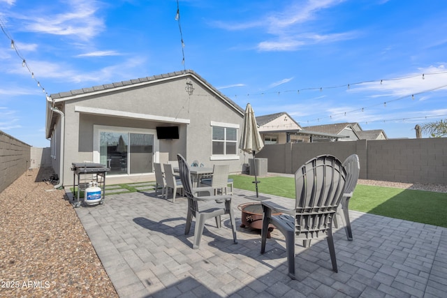 view of patio / terrace with a fenced backyard and an outdoor fire pit