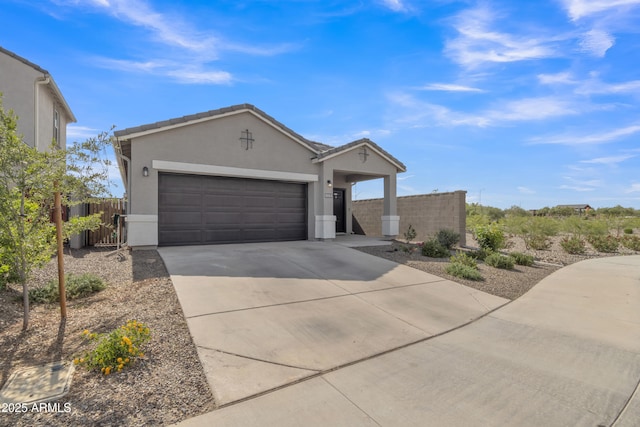 ranch-style house featuring stucco siding, concrete driveway, a garage, and fence