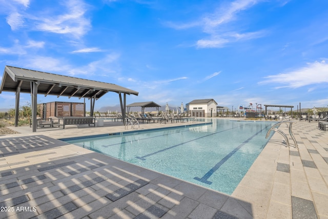community pool with a gazebo and a patio