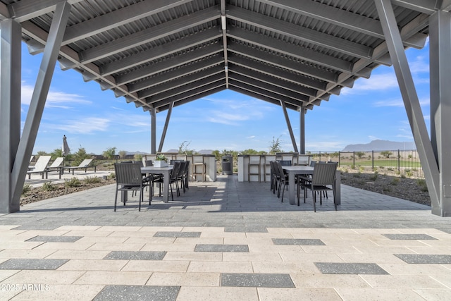 view of patio / terrace featuring outdoor dining area and a mountain view