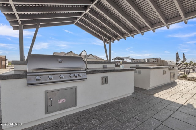 view of patio with exterior kitchen and grilling area