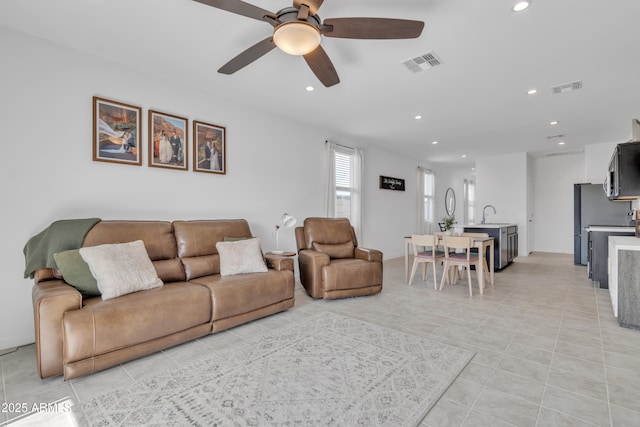 living room with ceiling fan, recessed lighting, and light tile patterned floors