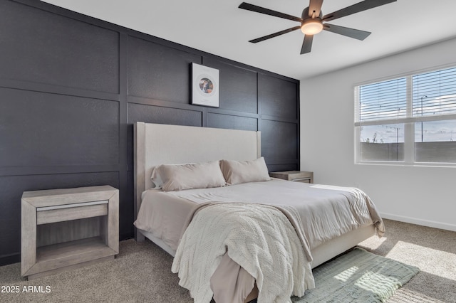 carpeted bedroom with baseboards and ceiling fan