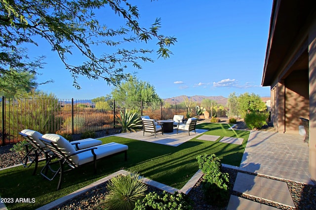 view of yard featuring a patio and a mountain view