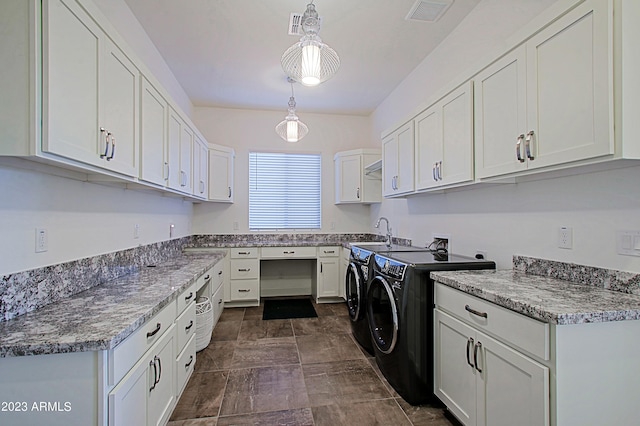 laundry area with dark tile flooring, independent washer and dryer, sink, cabinets, and washer hookup