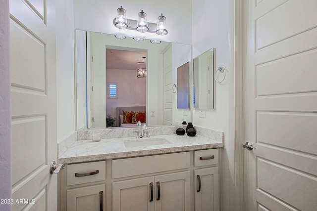 bathroom featuring a chandelier and large vanity