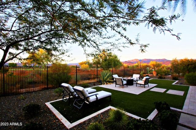 view of yard with an outdoor living space, a patio area, and a mountain view