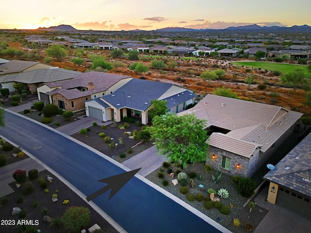 aerial view at dusk featuring a mountain view