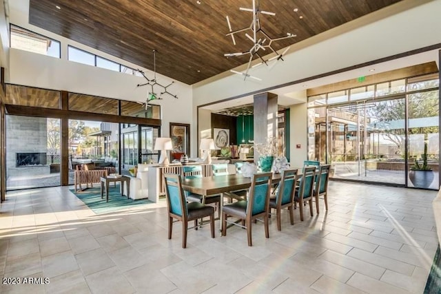 tiled dining space with high vaulted ceiling, plenty of natural light, and wood ceiling