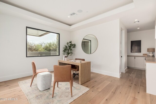 office space with visible vents, light wood-type flooring, and baseboards