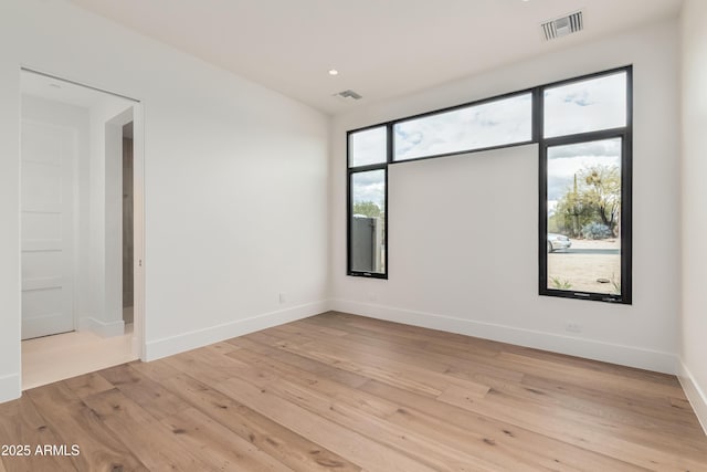 spare room featuring recessed lighting, visible vents, baseboards, and light wood-style flooring