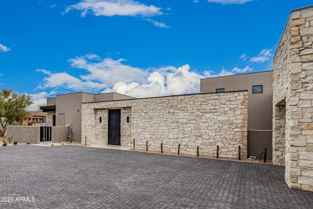 view of front of house with stone siding and stucco siding