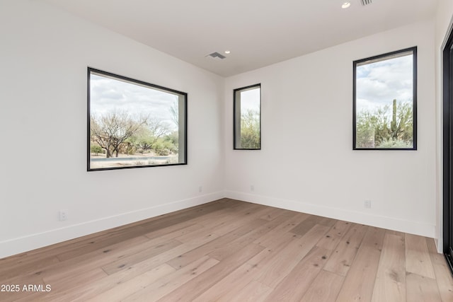 unfurnished room featuring recessed lighting, light wood-style flooring, and baseboards