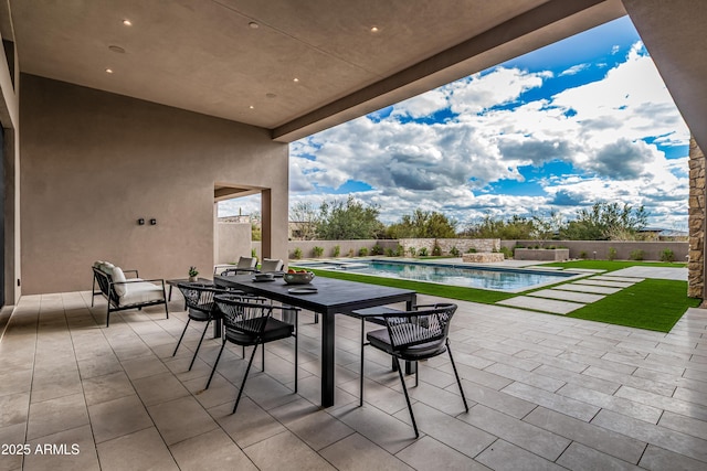 view of patio / terrace featuring a fenced in pool and fence