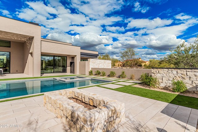 view of swimming pool featuring an in ground hot tub, a fenced in pool, and a patio