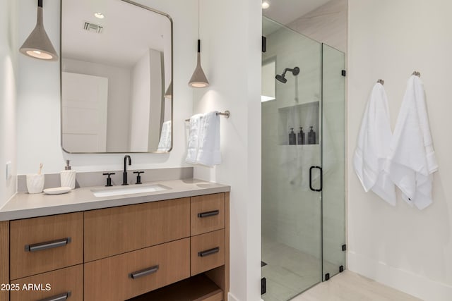 full bathroom featuring visible vents, a stall shower, and vanity