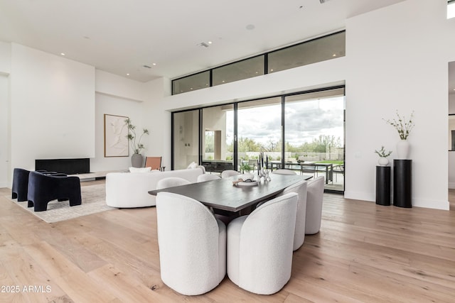 dining room featuring baseboards and light wood-type flooring