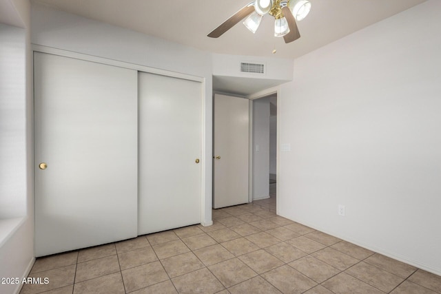 4336 E Aspen Ave, Mesa, AZ 85201 - unfurnished bedroom featuring a closet, light tile patterned flooring, and a ceiling fan
