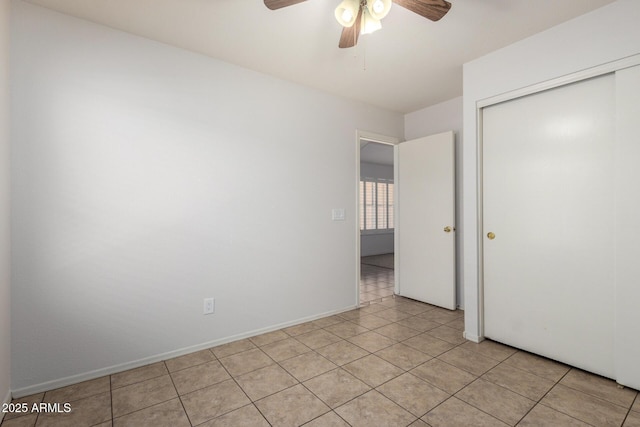 4336 E Aspen Ave, Mesa, AZ 85201 - unfurnished bedroom featuring a closet, light tile patterned floors, and a ceiling fan