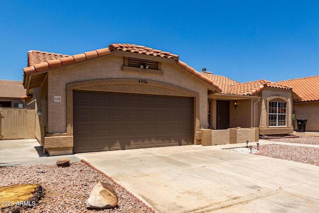 4336 E Aspen Ave, Mesa, AZ 85201 - mediterranean / spanish house with an attached garage, a tiled roof, stucco siding, and concrete driveway