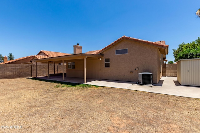 4336 E Aspen Ave, Mesa, AZ 85201 - rear view of house with a chimney, a patio area, a fenced backyard, and a storage unit