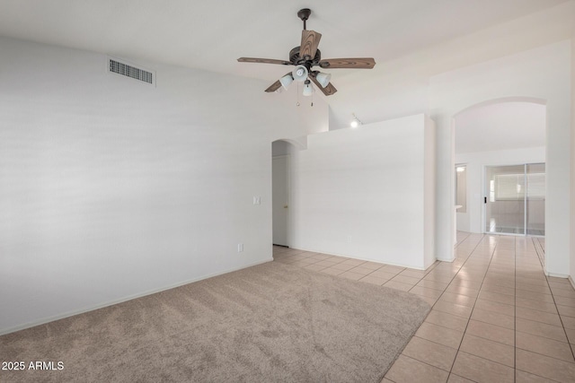 4336 E Aspen Ave, Mesa, AZ 85201 - spare room featuring arched walkways, a ceiling fan, light tile patterned floors, and high vaulted ceiling