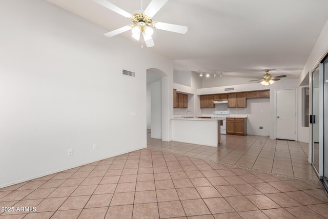 4336 E Aspen Ave, Mesa, AZ 85201 - unfurnished living room with vaulted ceiling, a ceiling fan, arched walkways, and light tile patterned floors