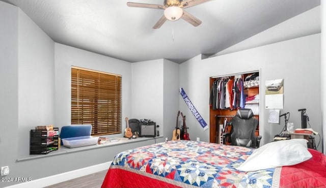 bedroom featuring ceiling fan, a closet, hardwood / wood-style floors, and lofted ceiling