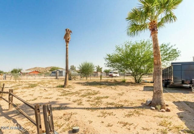 view of yard with a rural view