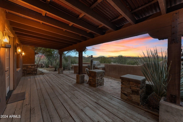 deck at dusk with area for grilling